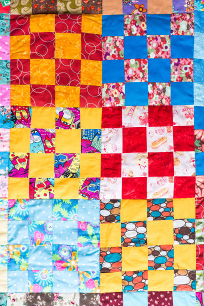 istock Part of symmetric geometry pattern color patchwork quilt as background. Colorful Scrappy blanket with pattern of small squares. Handmade 655506410
