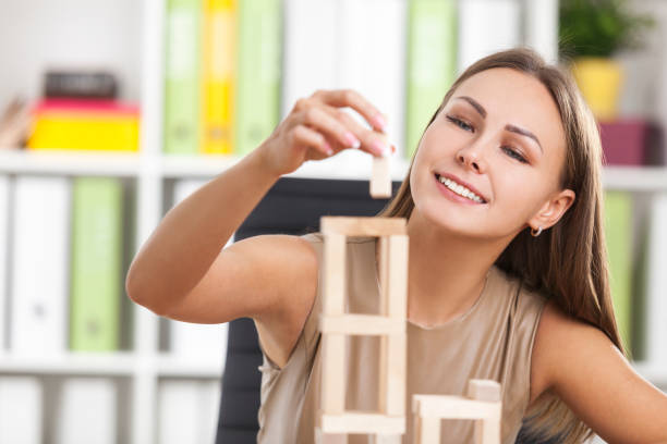 istock Young girl is playing with wood bricks 655513410