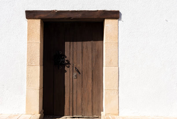 istock wooden door in a white wall 655519752