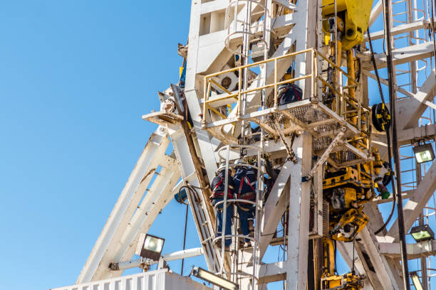 Fracking Oil Rig Construction Industry, oil and gas workers wellhead stock pictures, royalty-free photos & images