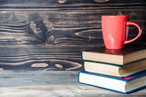 istock Hot coffee or tea, cocoa, chocolate cup on book with copy space for text 655548364