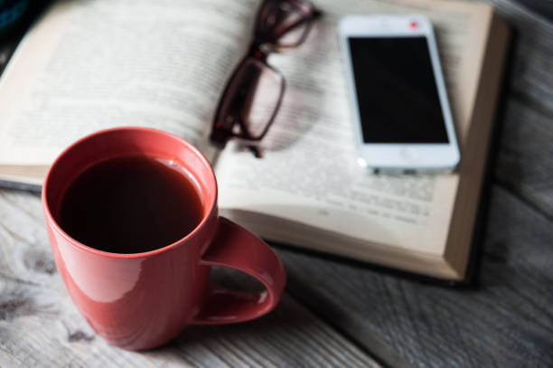 istock open book with phone, glasses and coffee or tea top view on table 655548398