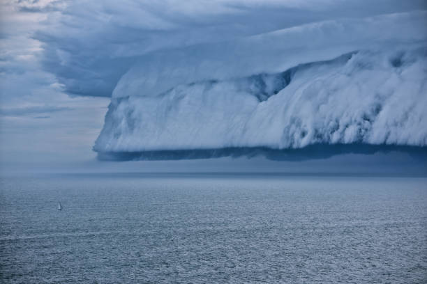 istock Epic supercell shelf cloud, Small boat fleeing 655548540