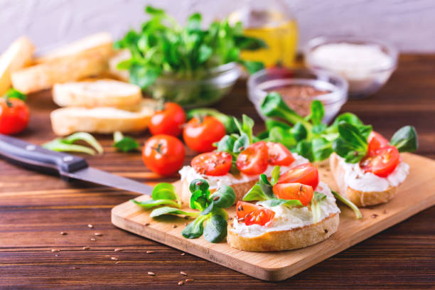 istock Bruschetta with ricotta, spinach, corn salad and cherry tomatoes 655549062