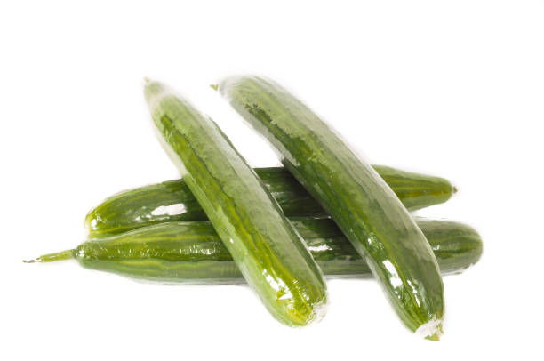 Cucumbers in heat shrink film on white stock photo