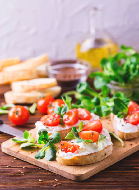 istock Bruschetta with ricotta, spinach, corn salad and cherry tomatoes 655549184
