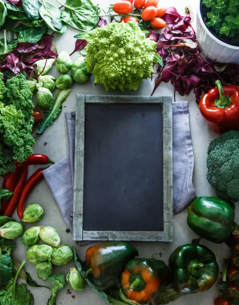 Fresh vegetables flatlay overhead frame.Blackboard with vegetables.. Food layout. Diet. Dieting plan
