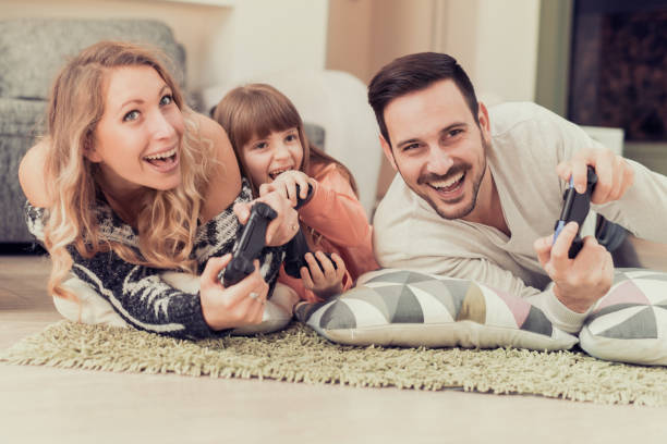 istock Young family playing video games 655554798