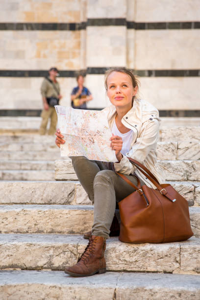 istock Gorgeous female tourist with a map 655554962