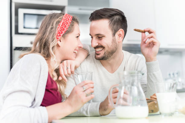 Cute couple having breakfast at home