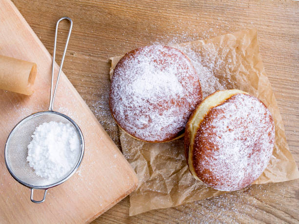 istock donuts with powdered sugar on a wooden table 655561302