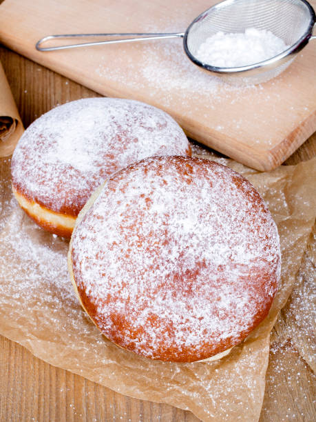 istock donuts with powdered sugar on a wooden table 655561356