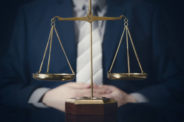 istock Weight scale of justice, lawyer in background 655563402