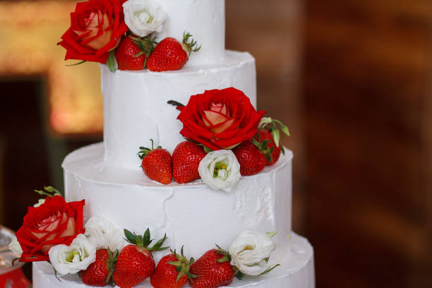 istock Wedding cake with strawberries and roses closeup. Dessert 655563838