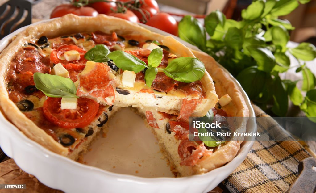 quiche Tart (Quiche) with tomatoes, basil, salami, black olives and cheese Baked Stock Photo