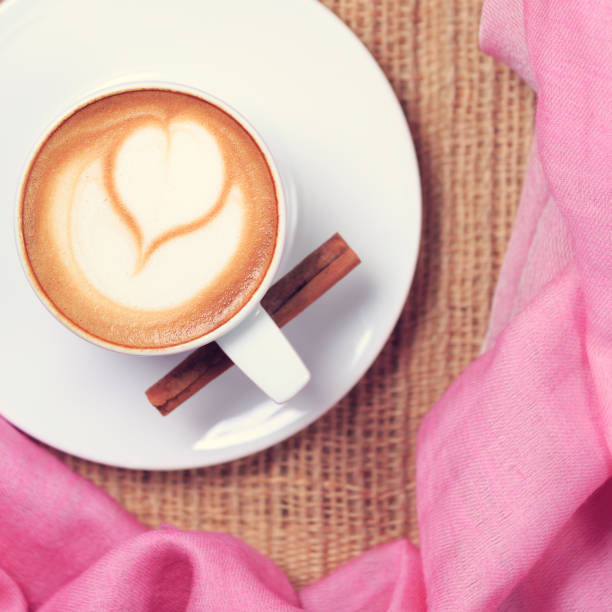 Coffee with pink scarf. Valentines concept. Rustic style. Flat lay view.