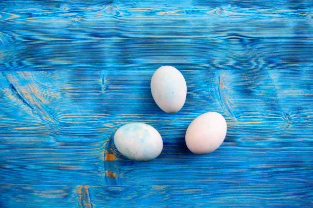 istock Easter eggs in soft colors on a blue shabby wooden table 655582024
