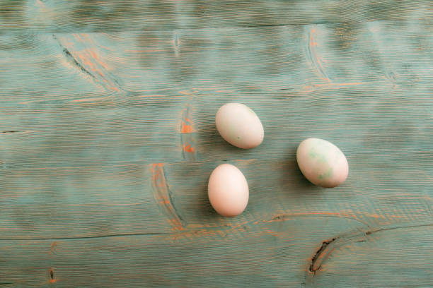 istock Easter eggs in soft colors on a white shabby wooden table 655582044