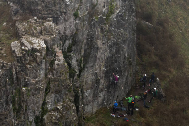 Group of rock climbers at Cheddar Gorge landscape Team of climbers ascend cliff in Somerset, UK, in one of Britain's most impressive areas of natural beauty cheddar gorge stock pictures, royalty-free photos & images