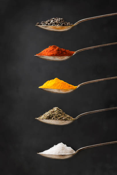Assorted spice and dried herb in spoon. Assorted colourful spice and dried herb in spoon in a row. Close up image. food styling stock pictures, royalty-free photos & images
