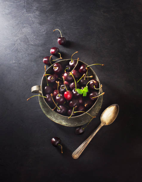 istock A cup of cherry on textured black background. 655623584