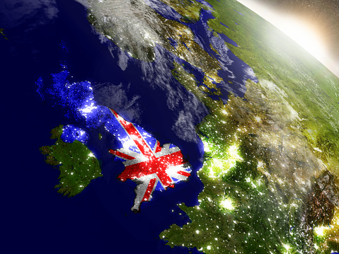 United Kingdom with embedded flag on planet surface during sunrise. 3D illustration with highly detailed realistic planet surface and visible city lights. 3D model of planet created and rendered in Cheetah3D software, 9 Mar 2017. Some layers of planet surface use textures furnished by NASA, Blue Marble collection: http://visibleearth.nasa.gov/view_cat.php?categoryID=1484