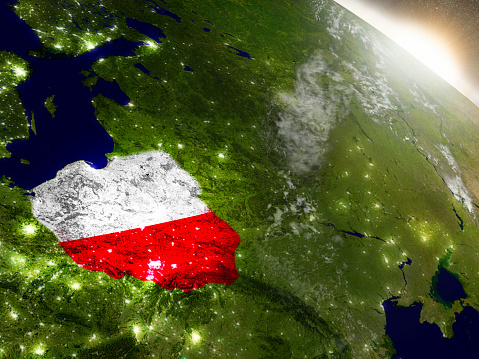 Poland with embedded flag on planet surface during sunrise. 3D illustration with highly detailed realistic planet surface and visible city lights. 3D model of planet created and rendered in Cheetah3D software, 9 Mar 2017. Some layers of planet surface use textures furnished by NASA, Blue Marble collection: http://visibleearth.nasa.gov/view_cat.php?categoryID=1484