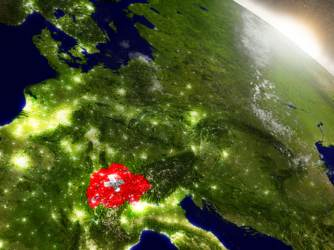 Switzerland with embedded flag on planet surface during sunrise. 3D illustration with highly detailed realistic planet surface and visible city lights. 3D model of planet created and rendered in Cheetah3D software, 9 Mar 2017. Some layers of planet surface use textures furnished by NASA, Blue Marble collection: http://visibleearth.nasa.gov/view_cat.php?categoryID=1484