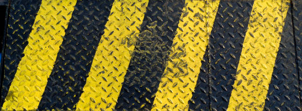 Black and yellow line paint on non-slip metal background Black and yellow line paint on non-slip metal background road chevron warning signs stock pictures, royalty-free photos & images