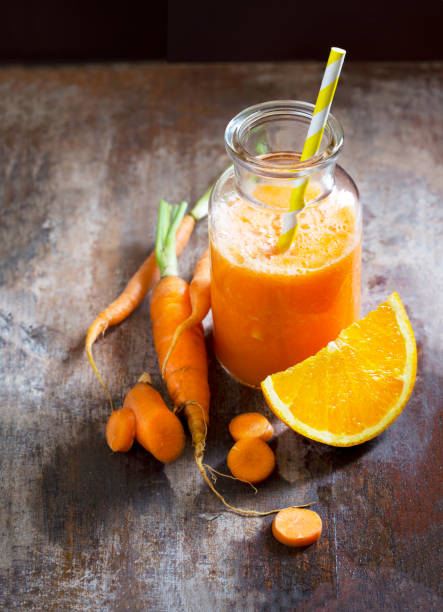 istock Orange and carrot juice on wooden background. 655631828