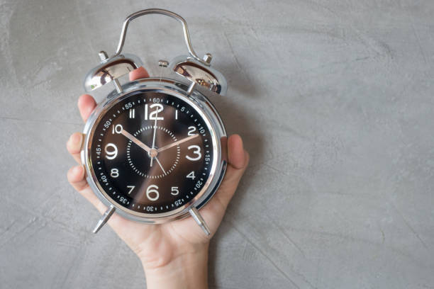 istock Woman Hand On Alarm Clock 655637496