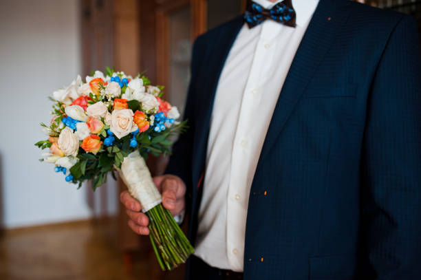 wedding bouquet at hand of groom