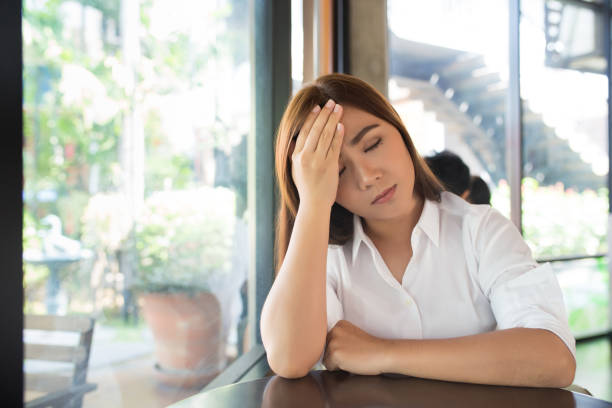istock Woman has head ache at coffee shop 655652744