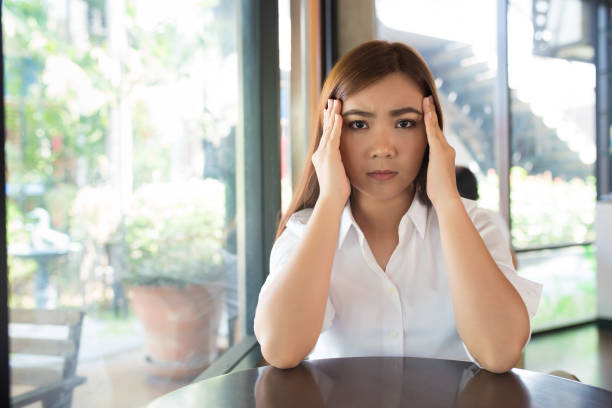 istock Woman has head ache at coffee shop 655652830