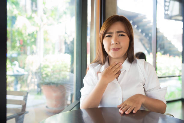 istock Woman has sore throat at coffee shop 655652888