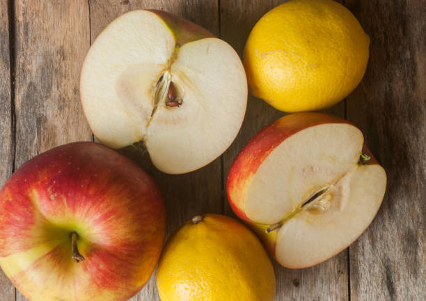 istock Apples and lemons on wooden background 655655494