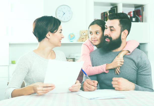 istock Parents signing property papers 655659852