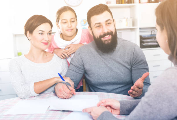 istock Parents signing property papers 655659866