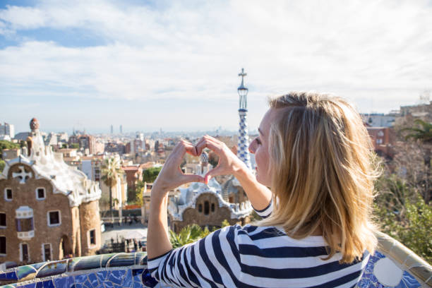 istock Young woman making heart shape frame in Barcelona 655662960