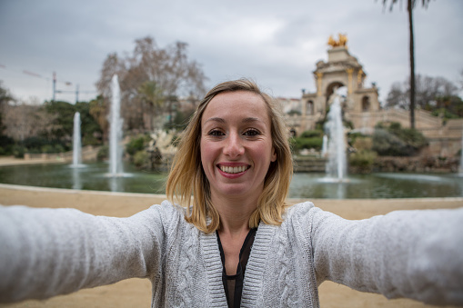 Young woman taking selfie at Fountain,Barcelona
