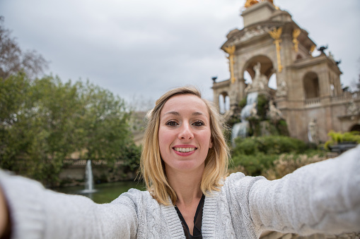 Young woman taking selfie at Fountain,Barcelona