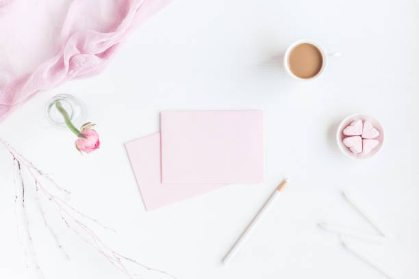 istock Workspace with notebook, cup of coffee, paper blank, pink flower 655671304