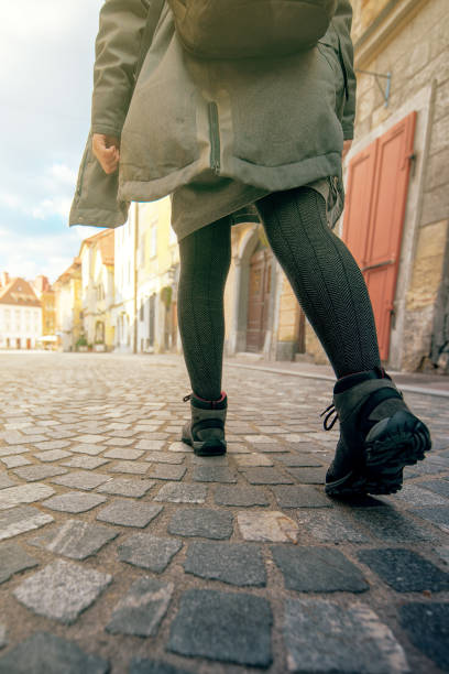 istock Low angle view of female tourist with backpack walking 655675518