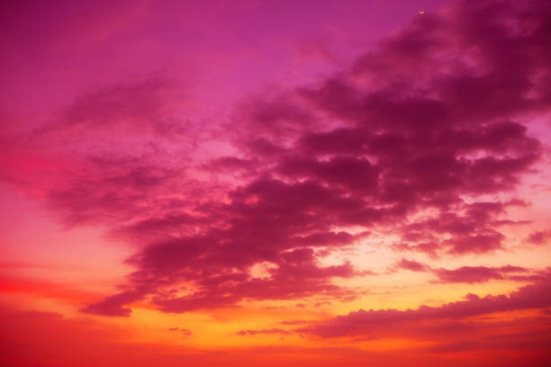 Colorful tropical sky with golden clouds at sunset time
