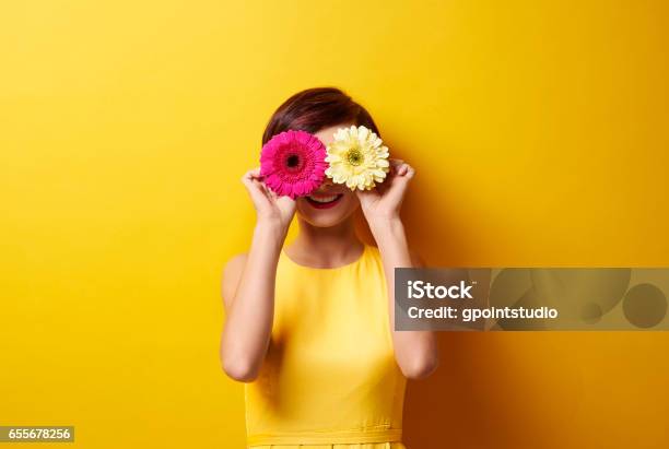 Playful Brunette Covering Her Eyes Stock Photo - Download Image Now - Flower, Springtime, Women