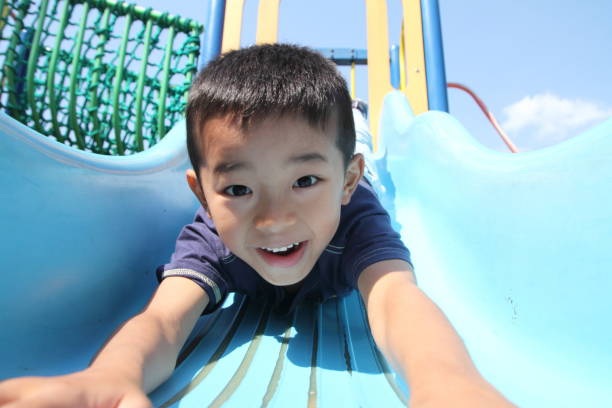 istock Japanese boy on the slide (first grade at elementary school) 655681220
