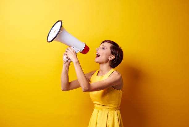 istock Female model using bullhorn in photo session 655682050