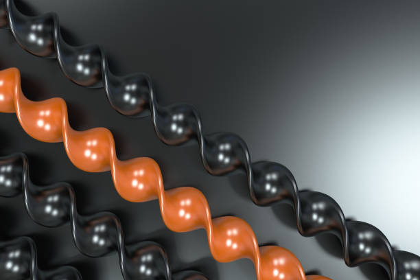 istock Black and orange plastic spiral sticks on black background 655684250