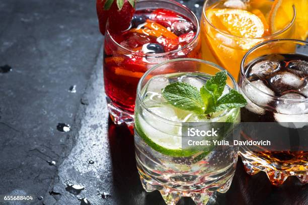 Assortment Of Fresh Iced Fruit Drinks On A Black Background Stock Photo - Download Image Now