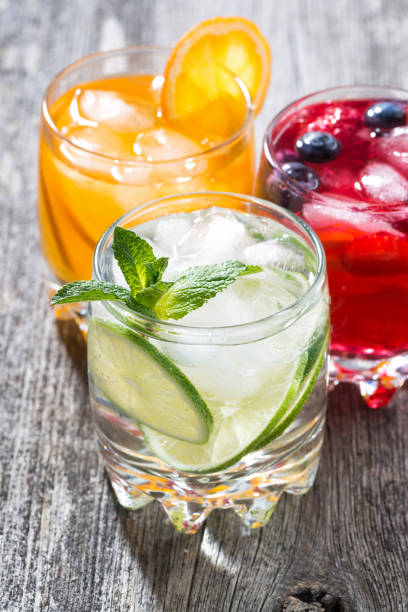 istock assortment of fresh iced fruit drinks on wooden background, vertical 655688610